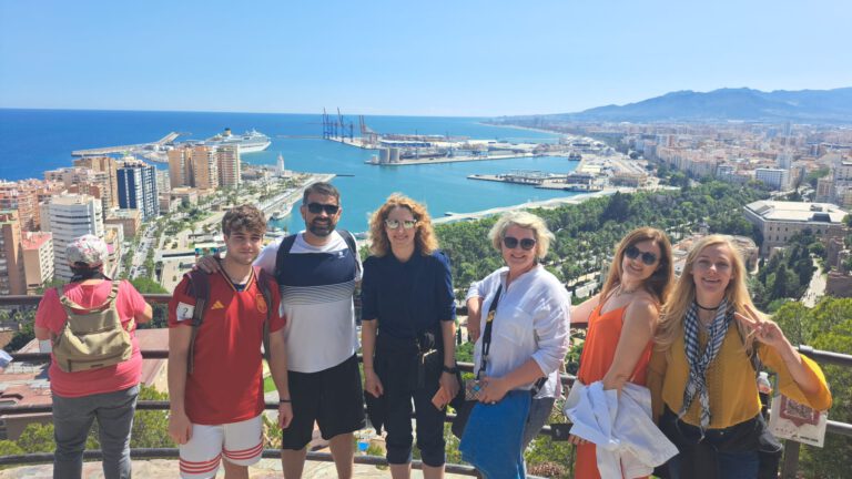 Group at a viewpoint overlooking Málaga and its port